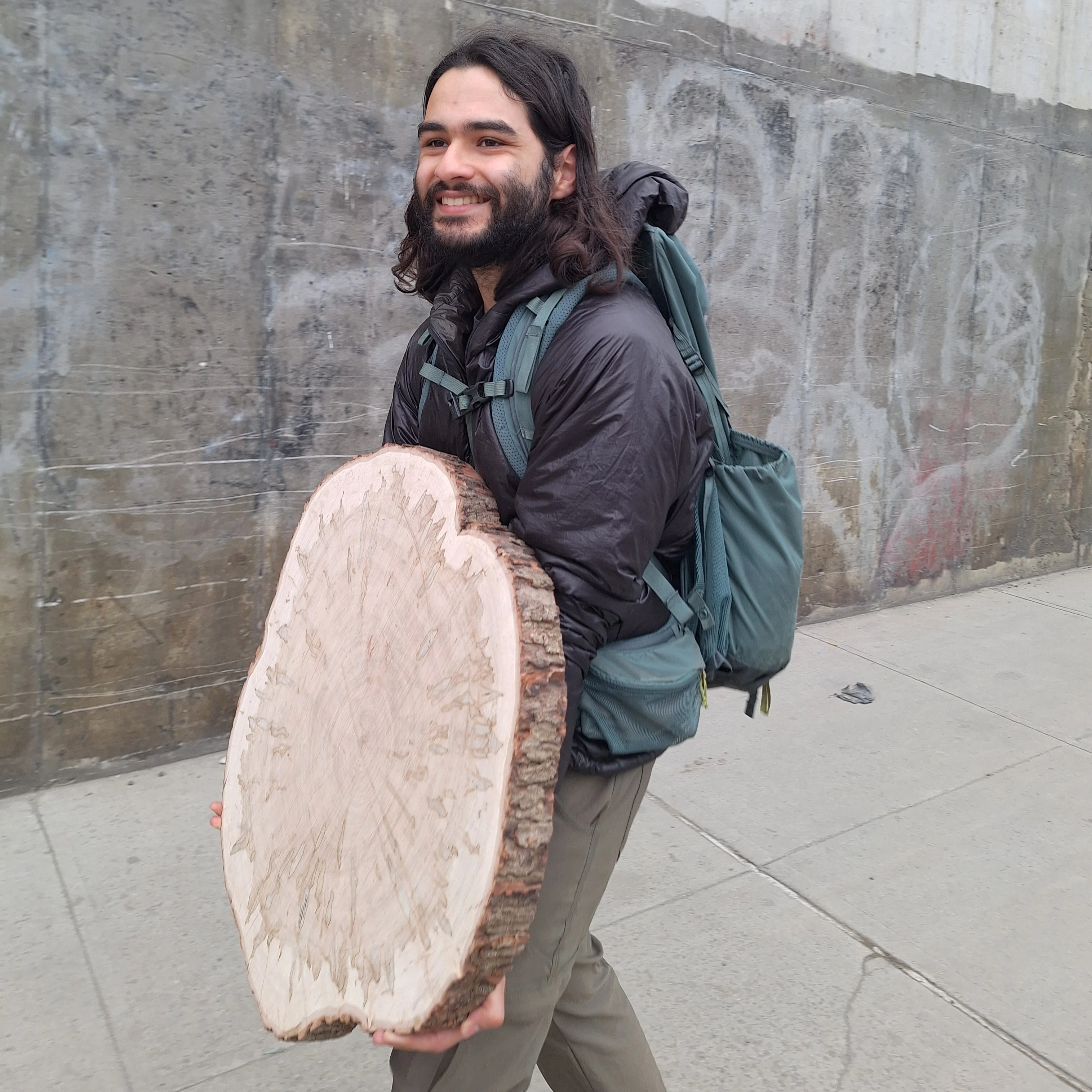 James carrying the slab of wood outside the thrift store