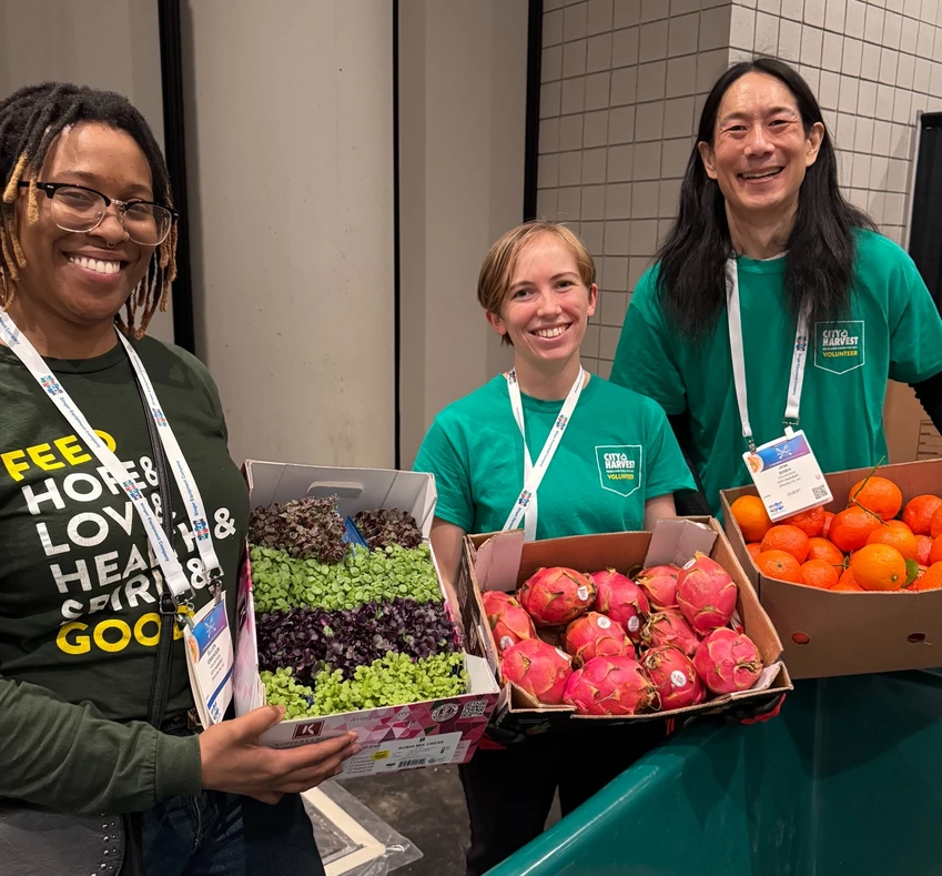 Me and other volunteers holding rescued produce