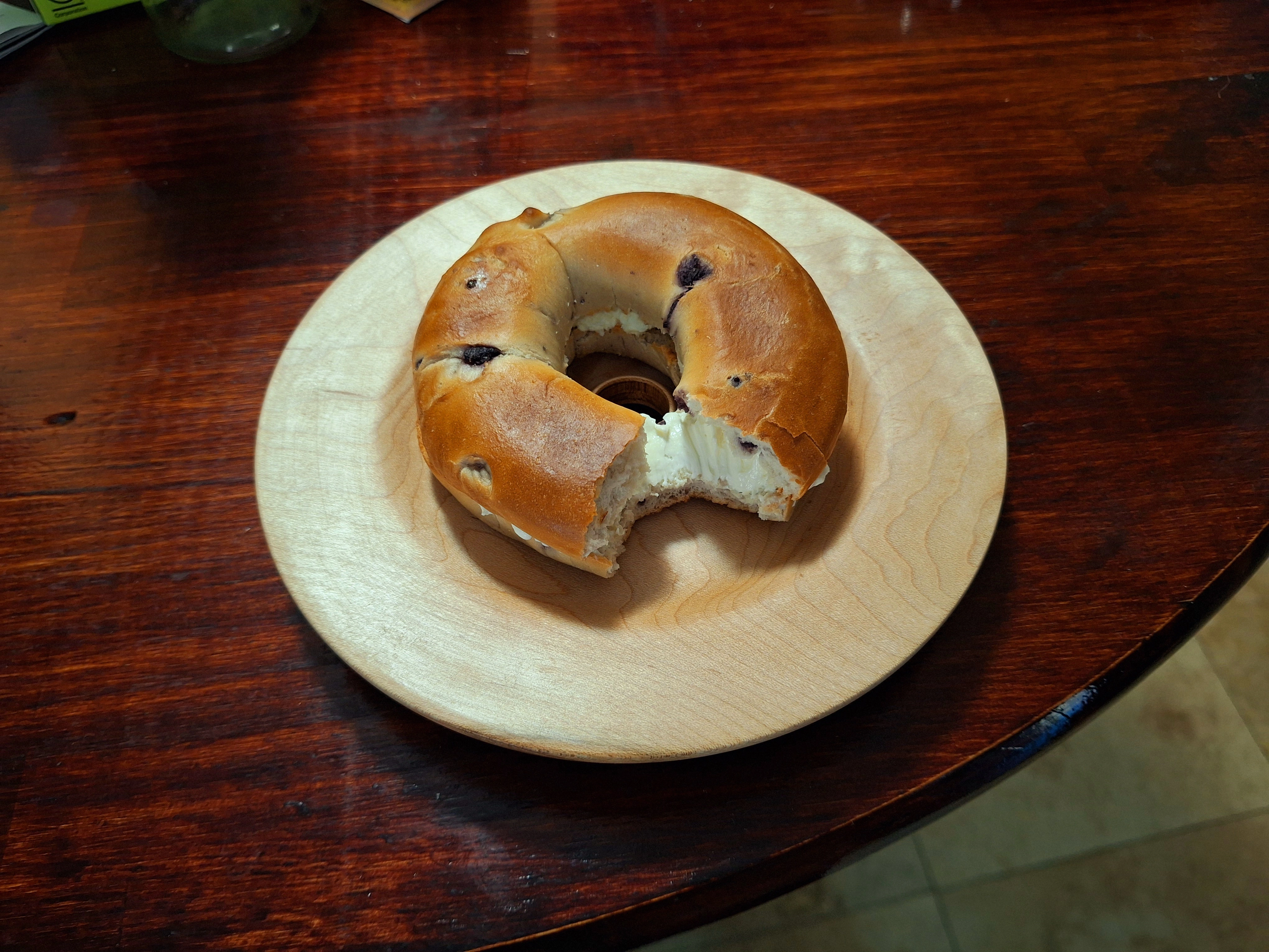 Bagel plate with a hole in the middle and a bagel on top